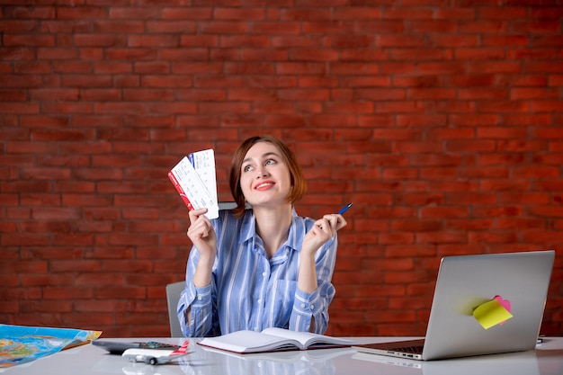 Front view travel agent behind her working place with plane tickets agency map service global assistant world operator managers