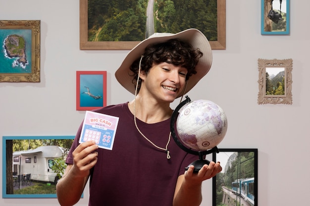 Free photo front view traveler holding world globe