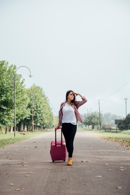 Front view of traveler with her baggage