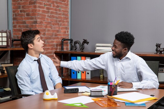 Front view two business partners in formal wear working in office