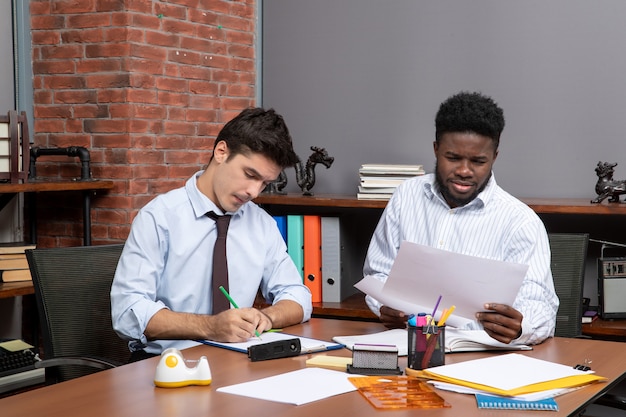 Free photo front view two business partners having business negotiations in modern office