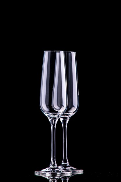 Front view two champagne glasses on black surface