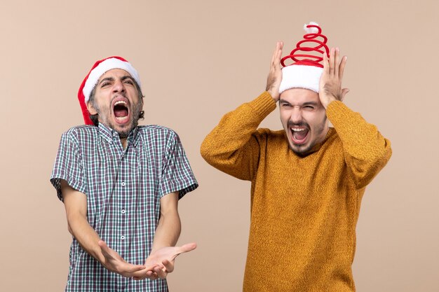 Front view two guys one singing loud and the other holding his head on beige isolated background