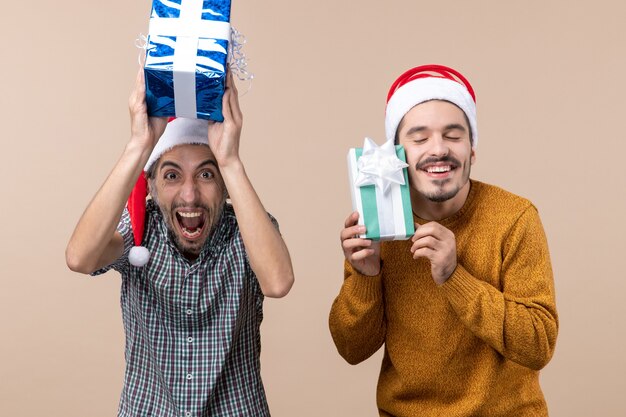 Front view two happy men holding christmas presents