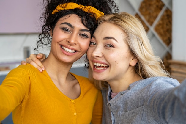 Front view of two happy women taking a selfie