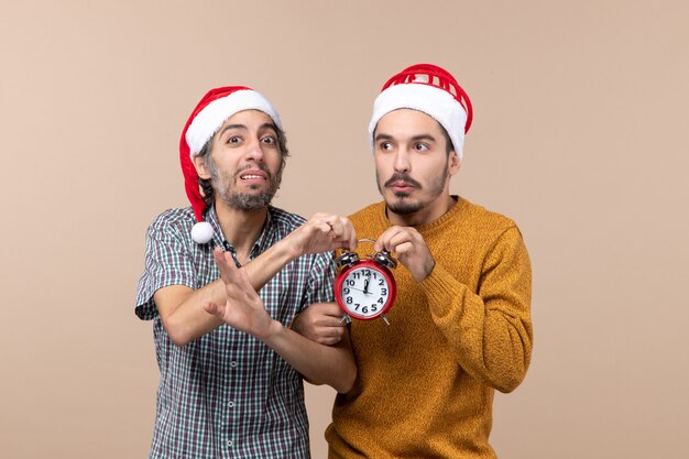 Front view two men both holding red clock on isolated background