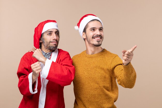 Foto gratuita vista frontale due uomini che guardano a destra su sfondo beige isolato