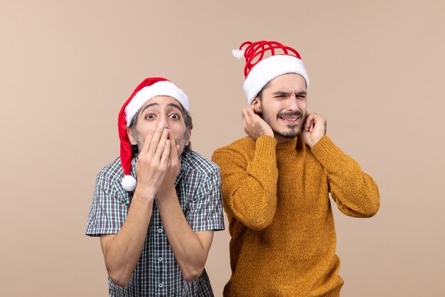 Front view two men one putting hands to his mouth the other covering his ears on isolated background