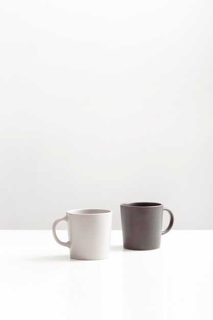 Front view of two mugs with copy space