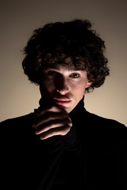 Front view unknown young man posing in studio