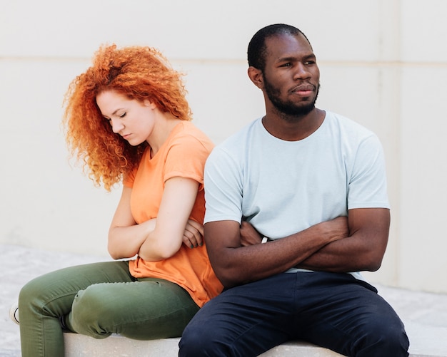 Free photo front view of upset interracial couple