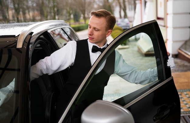 Front view valet in suit working