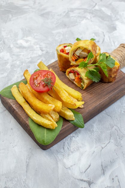 Front view vegetable pate rolls with french fries on a white surface