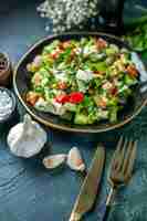 Free photo front view vegetable salad consists of cucumber cheese and tomatoes on a dark-blue background