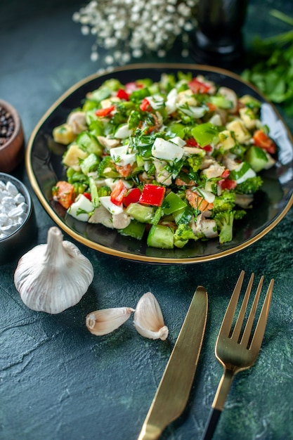 front view vegetable salad consists of cucumber cheese and tomatoes on a dark-blue background