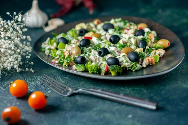 front view vegetable salad with mayyonaise and olives on dark blue surface meal holiday health dish photo dinner colors