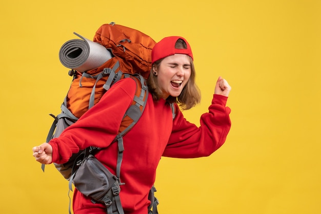 Front view very excited female traveler with backpack expressing her feelings