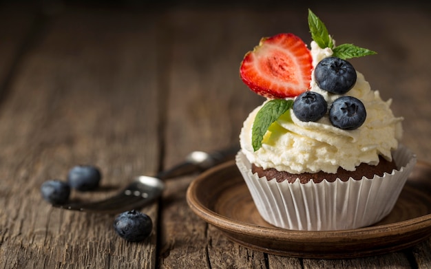 Front view view tasty cupcake with strawberry and blueberry