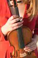 Free photo front view of violin held by woman