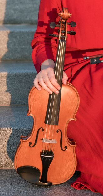 Front view of violin held by woman