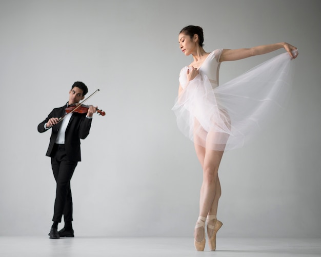 Front view of violin musician with ballerina