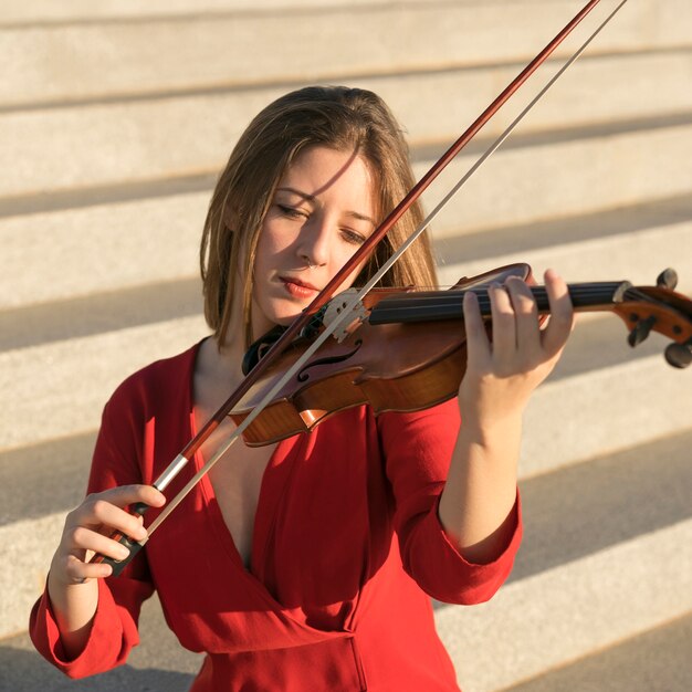 Front view of violinist playing on steps