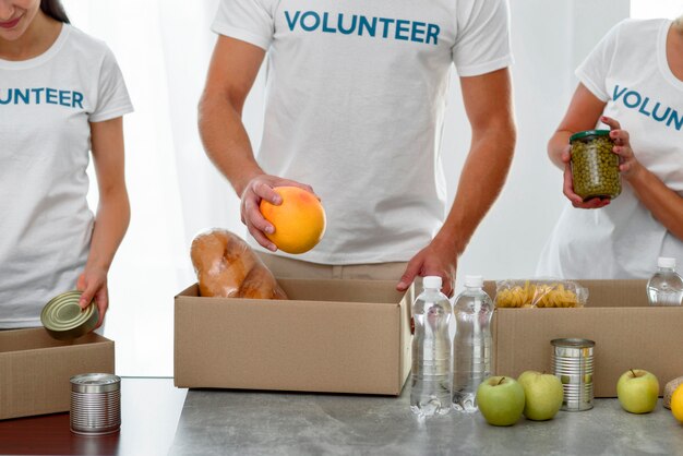 Front view of volunteers packing boxes with food