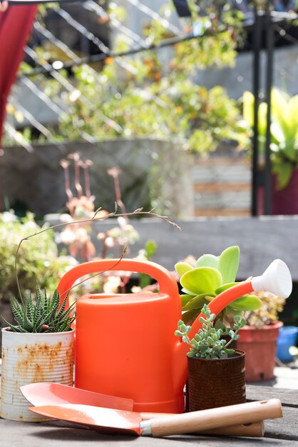 Front view watering can on wooden tabl