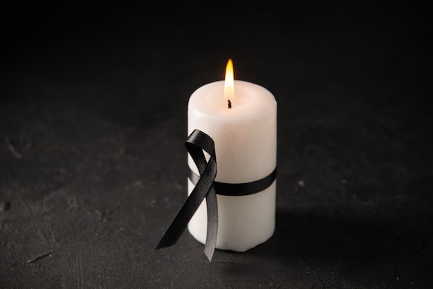 Front view of white candle with black