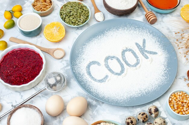 Front view white flour inside plate with nuts seeds and eggs on light background pie nut dough bake food cake biscuit cook photo color