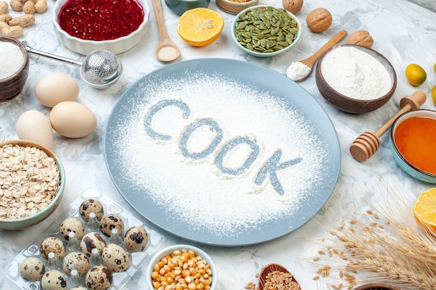 Front view white flour inside plate with nuts seeds and eggs on white background nut dough bake food color cake biscuit pie cook photo