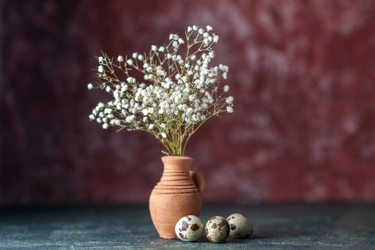 Free Photo front view white flowers with quail eggs on a dark background beauty tree branch color photo nature food bird