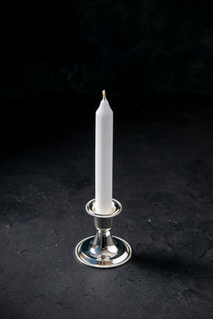 Free Photo front view of white long candle on a dark wall