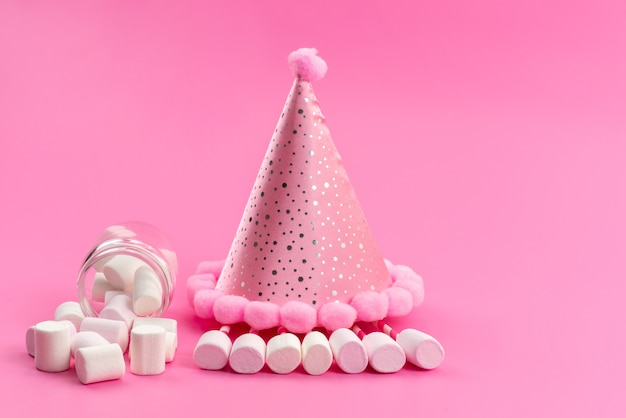 Free photo a front view white marshmallows inside can around pink birthday cap on pink