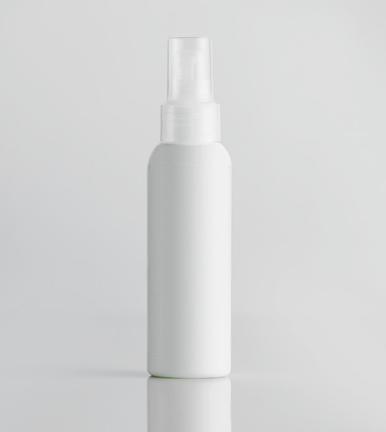 Free photo front view white plastic bottle with sprayer on a white wall