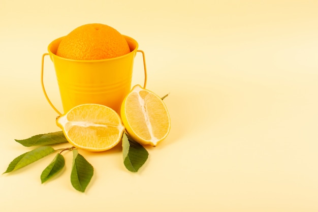 A front view whole orange inside orange basket along with sliced lemon ripe fresh juicy mellow isolated on the cream background citrus fruit orange