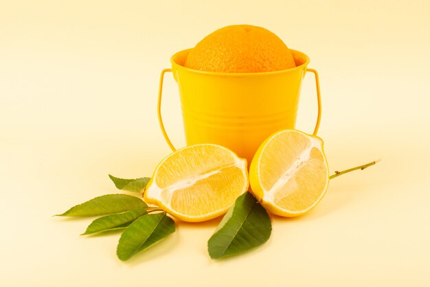 A front view whole orange inside orange basket along with sliced lemon ripe fresh juicy mellow isolated on the cream background citrus fruit orange