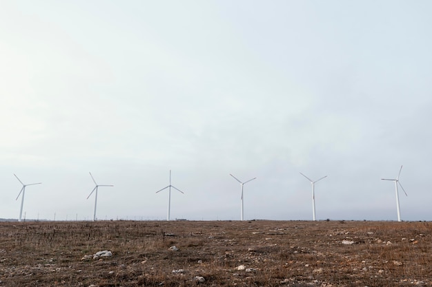 Front view of wind turbines in the field generating energy