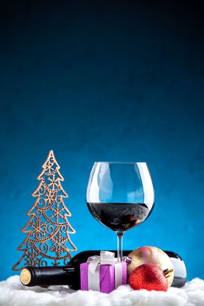 Front view wine glass and bottle horizontal on blue background