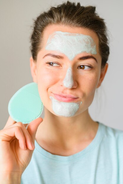 Front view of woman applying face cream