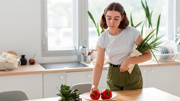 Front view woman arranging vegetables at home