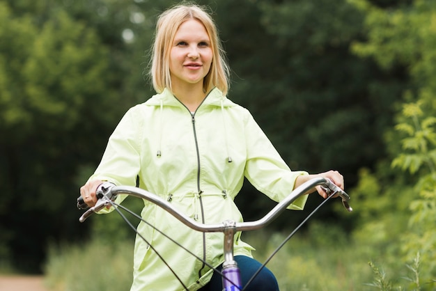 Free photo front view woman on bicycle looking away