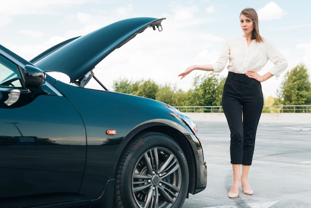 Front view of woman and black car