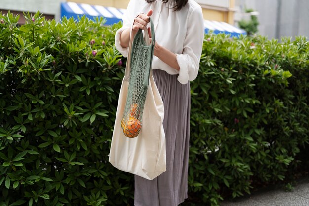 Front view woman carrying fruits