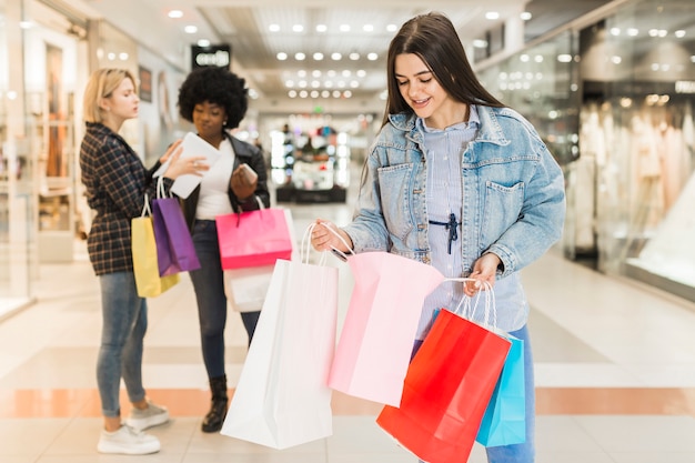 Front view woman checking her shopping bags