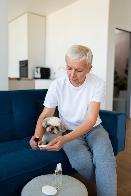 Front view woman cleaning dog