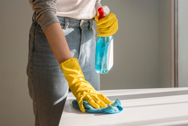 Front view of woman cleaning surface
