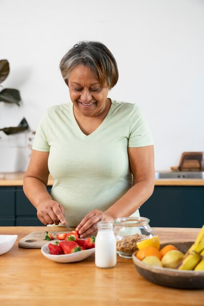 Front view woman cooking at home