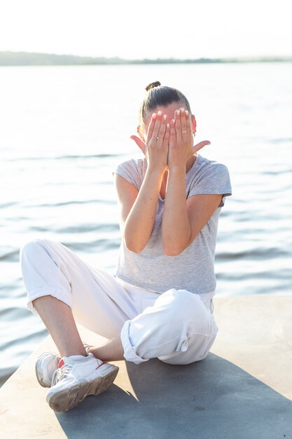 Free photo front view woman covering her eyes