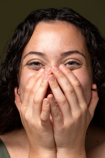 Free photo front view woman covering her face